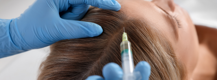 A technician injecting in a girl’s head for clinical hair loss treatment for women
